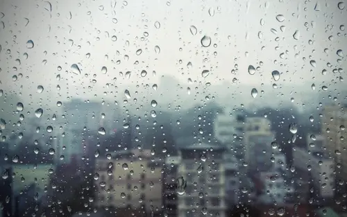 Image "Raindrops on a window with a view of the city" (2880x1800)