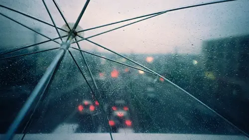 Image "Raindrops on a transparent umbrella and blurred car lights on the background" (1920x1080)