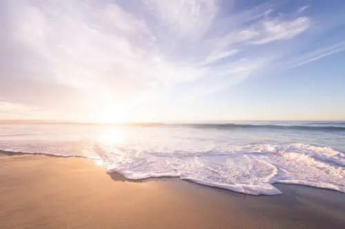 Image "A calm seascape with waves rolling on the sandy shore and the soft light of the dawn" (4928x3280)