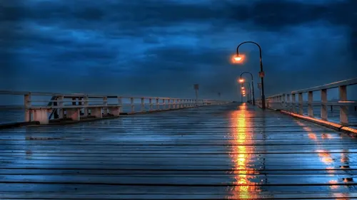 Image "A wet pier with reflections of lanterns in puddles under a dark sky" (3200x1800)
