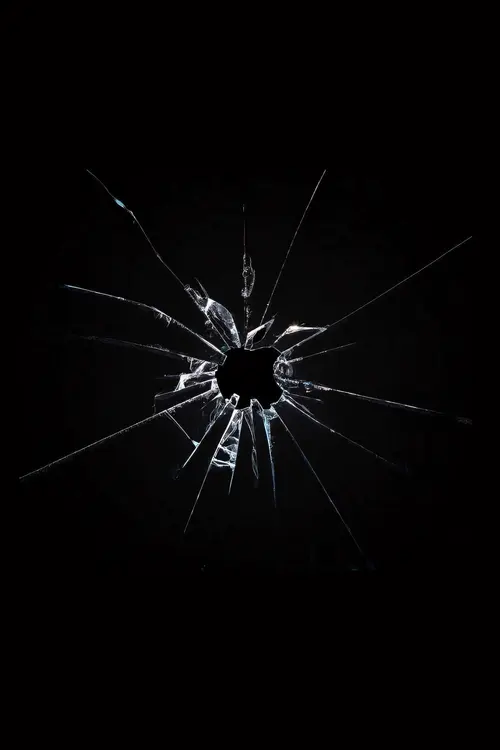 Image "Broken glass with a hole on a dark background" (1332x1998)